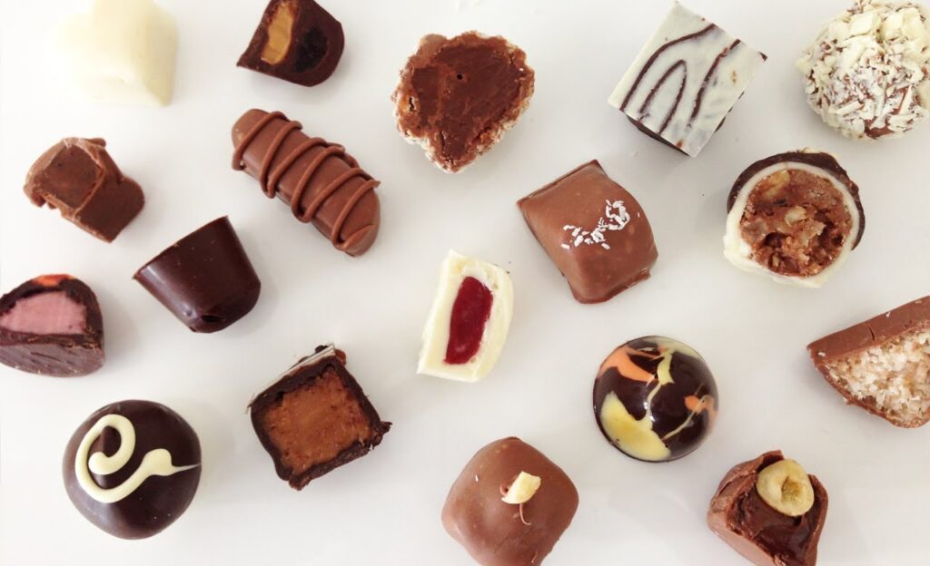 Assorted chocolate truffles and pralines on white