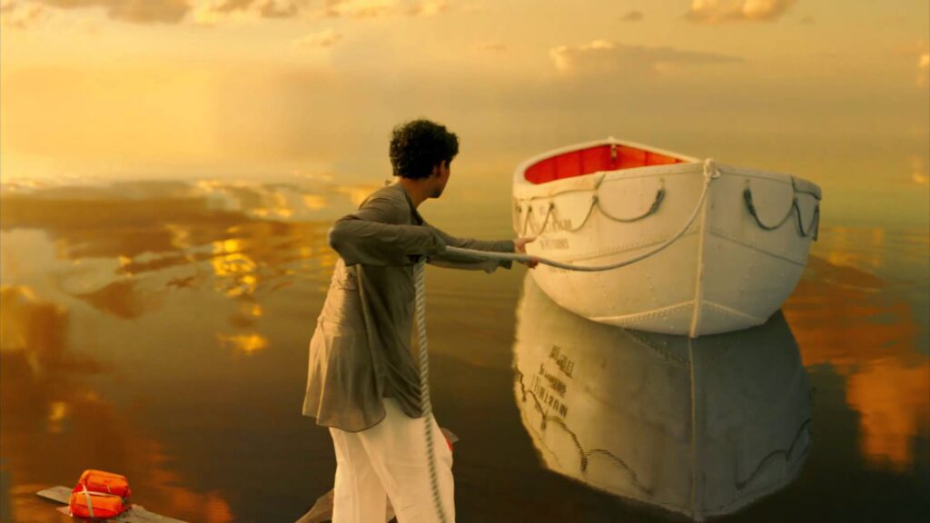 Person pulling white rowboat across golden water